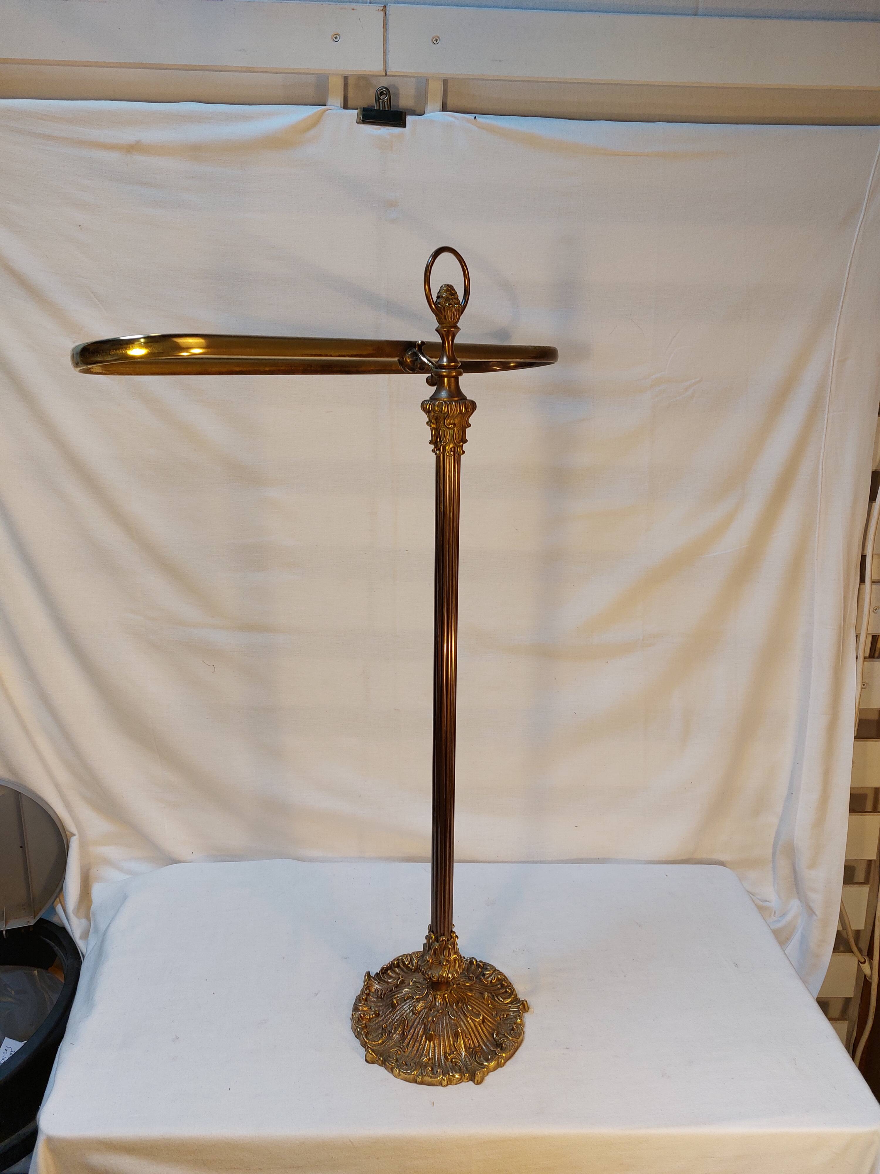 Old golden brass towel rack on baroque style foot