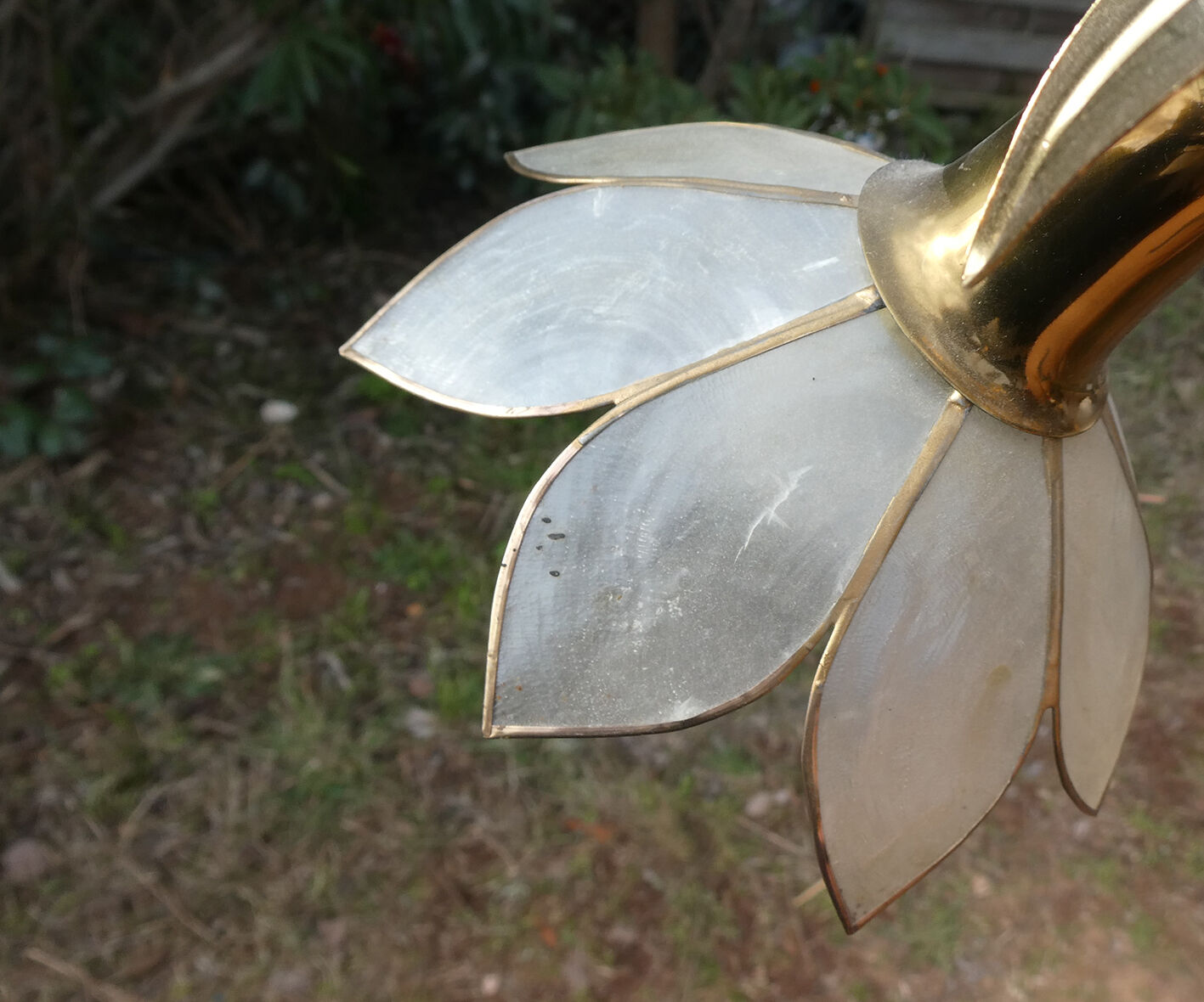 Brass chandelier and flowers in mother-of-pearl petals