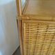 Storage column, wooden bookshelf and woven rattan.