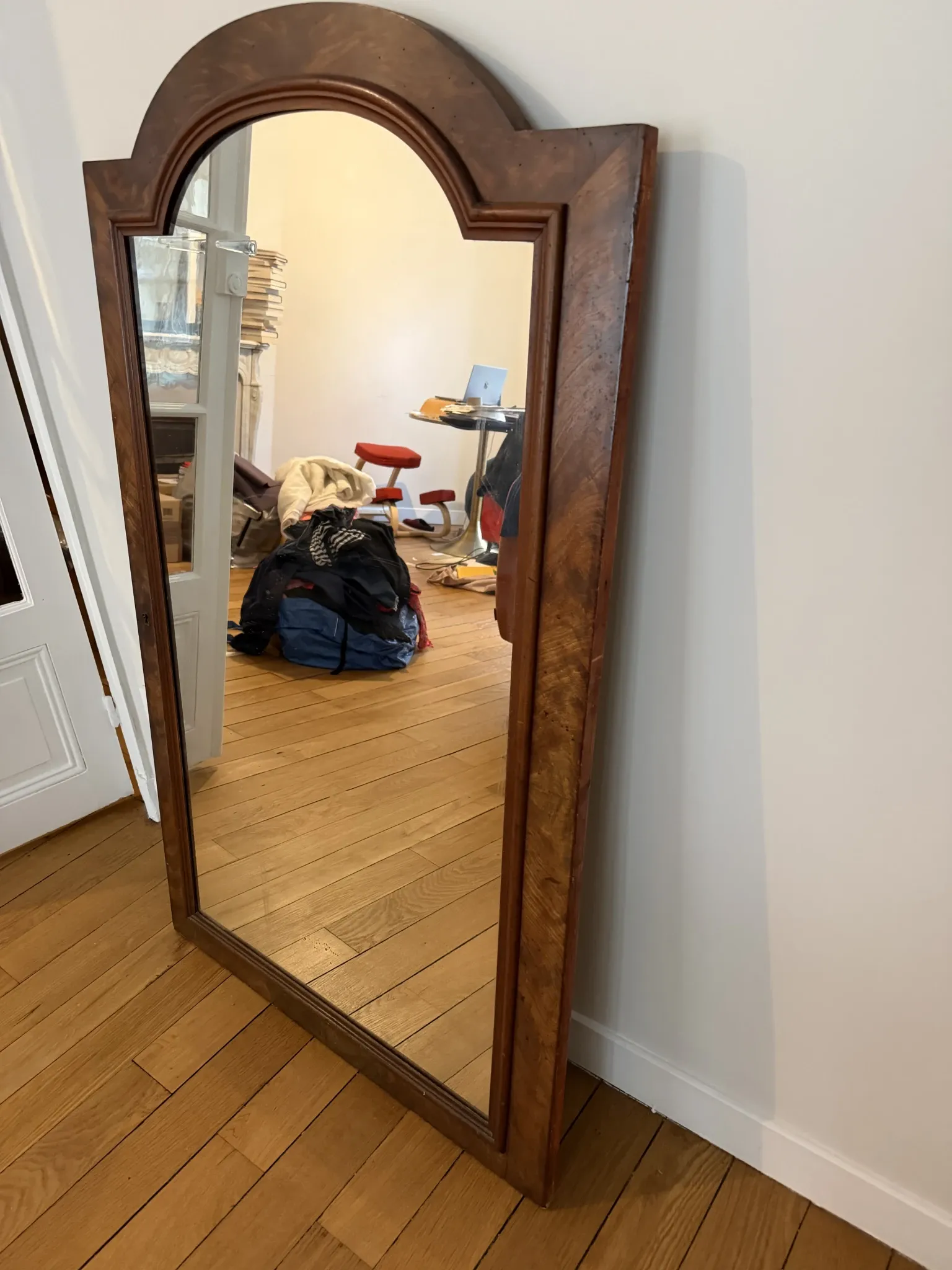 Large curved mirror with a wooden frame