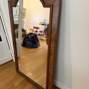 Large curved mirror with a wooden frame