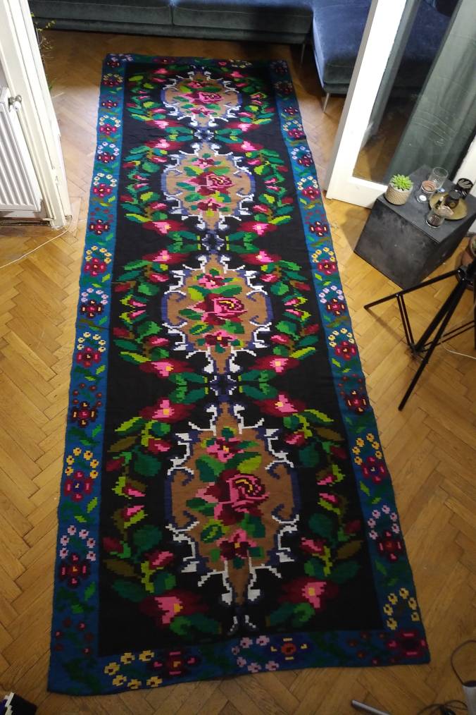 Romanian floral runner rug on blue background