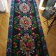 Romanian floral runner rug on blue background