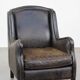 Black cow leather armchair finished with decorative nails, industrial style