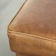 Cowhide ottoman with a beautiful patina finished with decorative nails