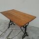 Solid oak bistro table with a cast iron base, signed.