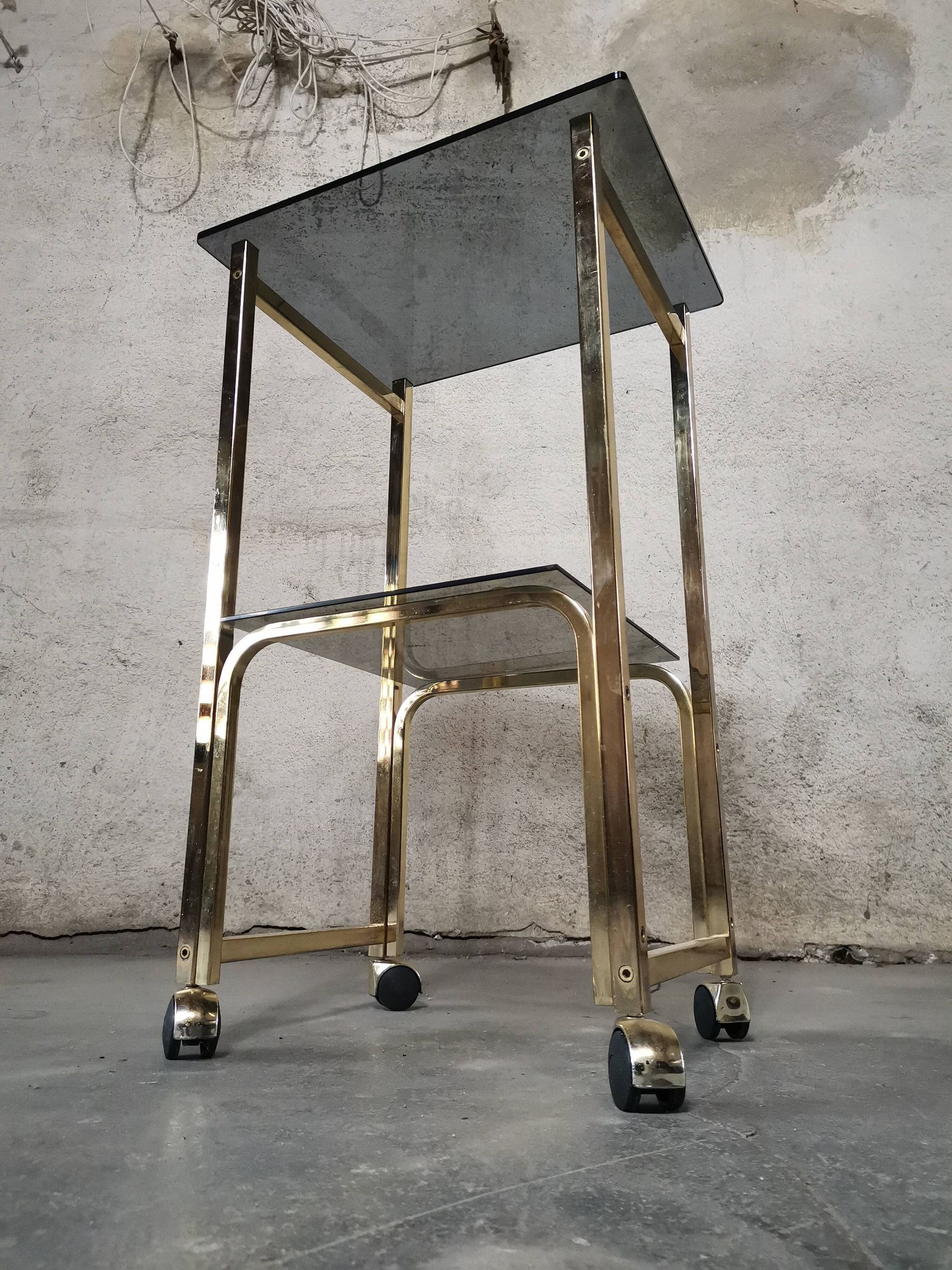 Side Table 1970s smoked glass/gold/wheels