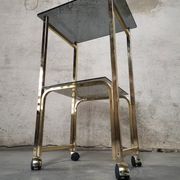 Side Table 1970s smoked glass/gold/wheels