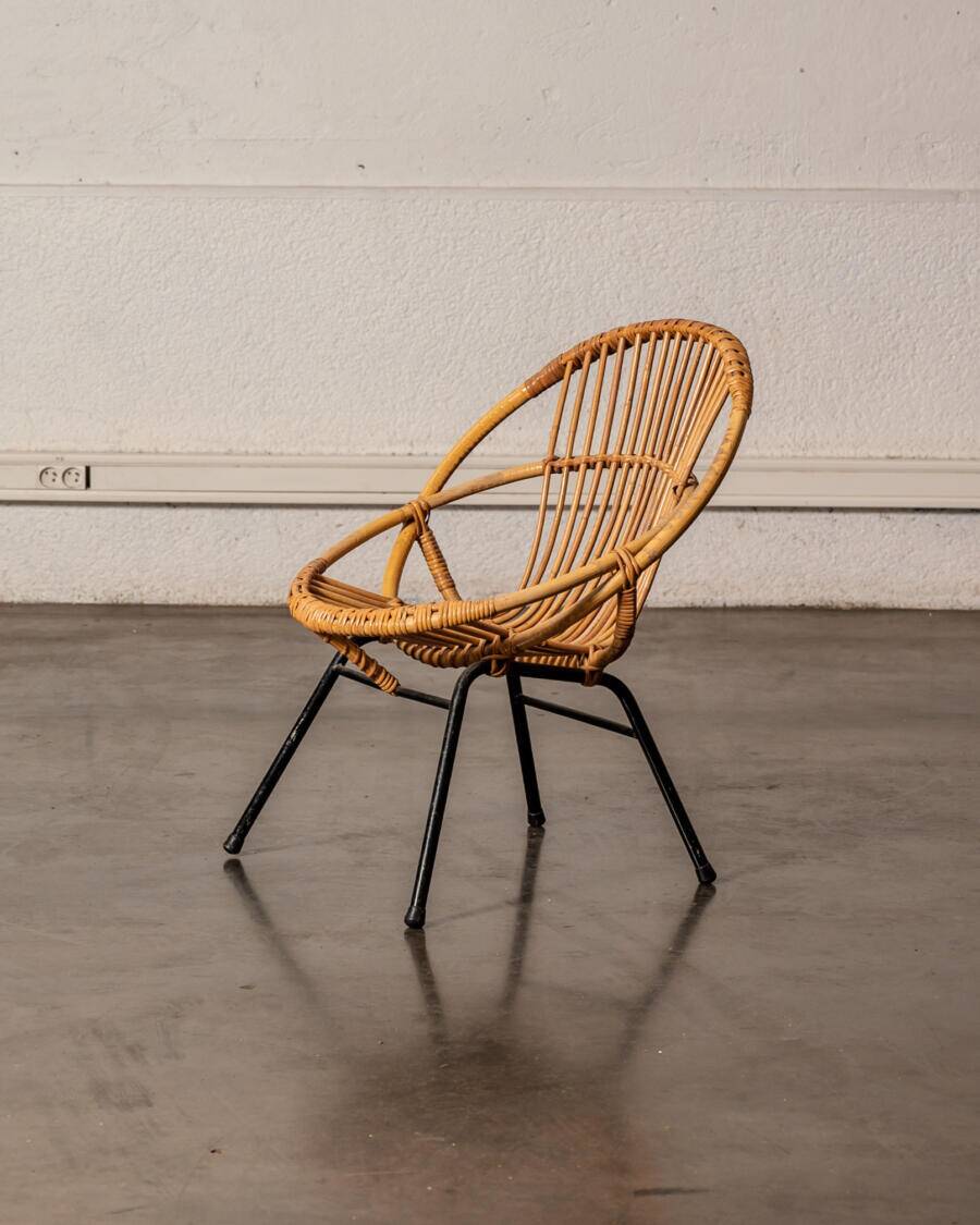 Rattan armchair with metal legs