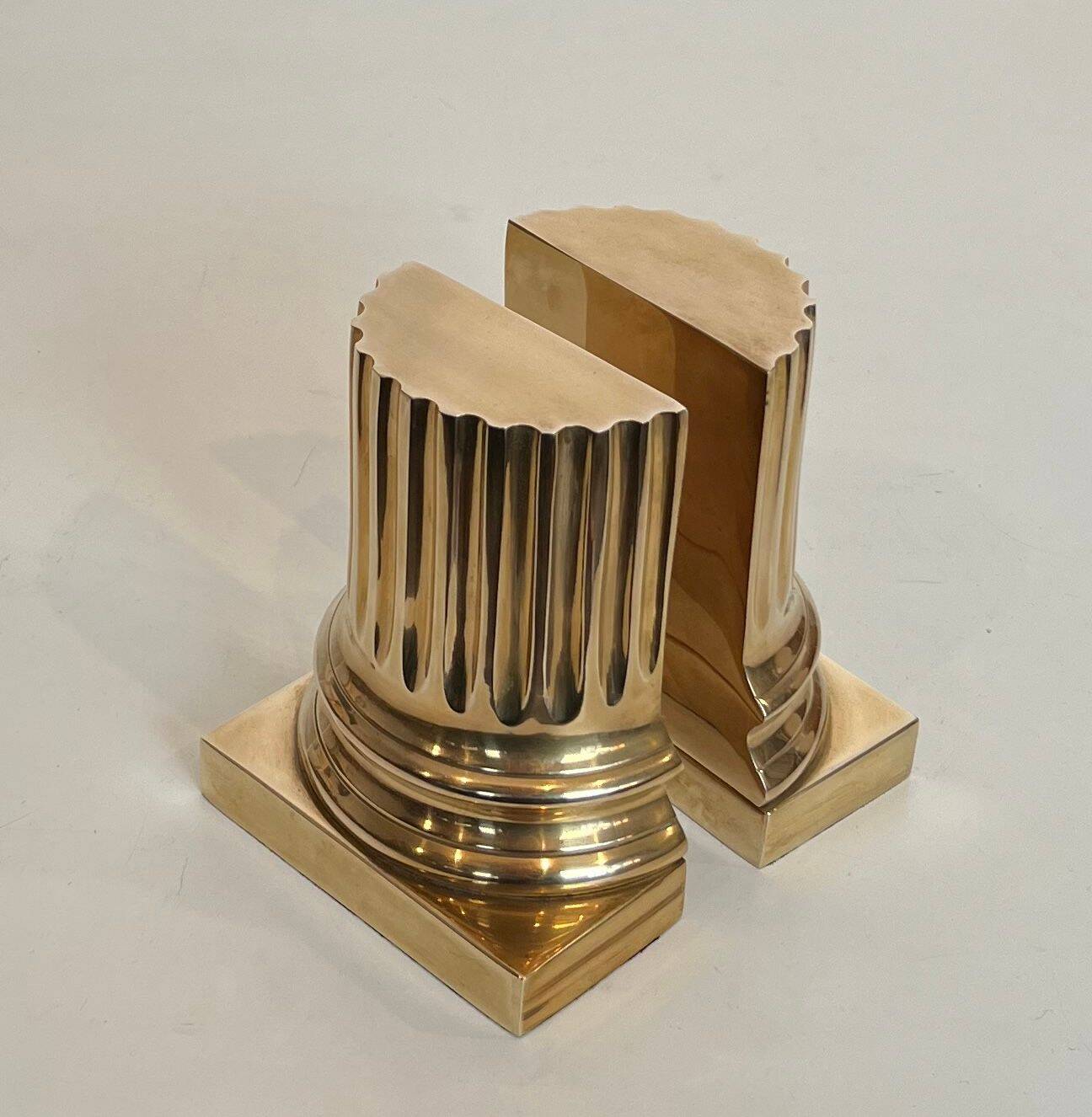 A pair of brass bookends representing columns.