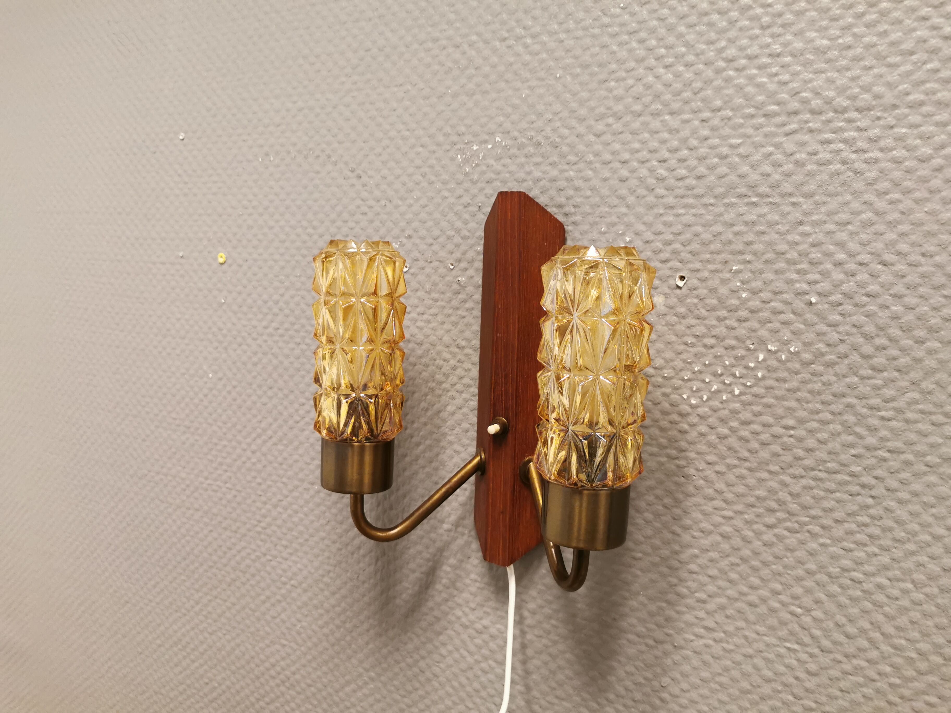 Older Danish wall lamp, with double light source, made of teak wood, amber colored glass and brass