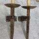 Pair of brutalist wall sconces in hammered and patinated iron, work from the years.