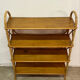 Vintage shelf on legs made of rattan and wood.