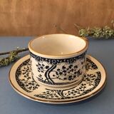Large stoneware cup and saucer with delicate floral patterns