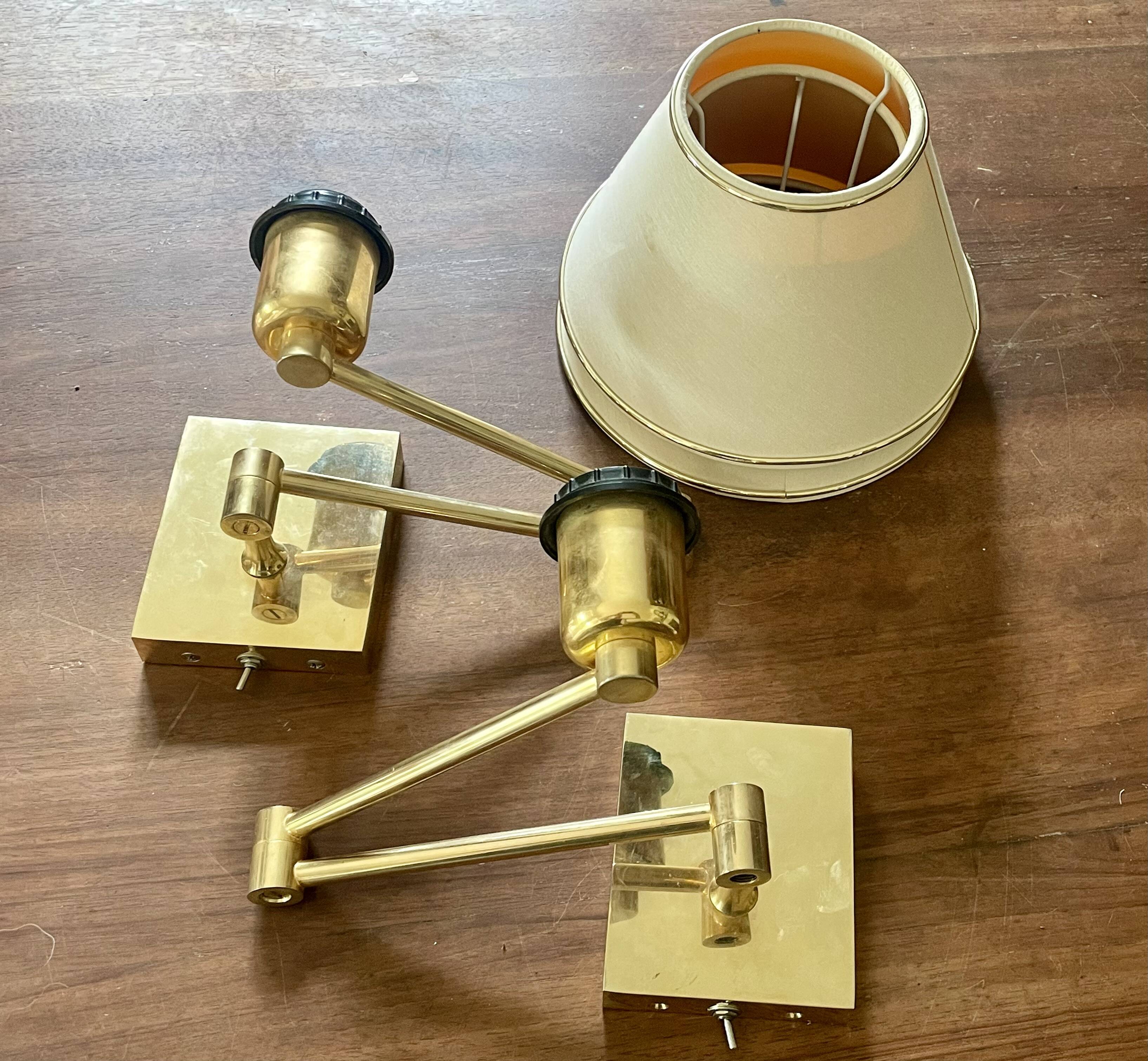 Pair of vintage brass wall lights with adjustable arms.