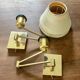 Pair of vintage brass wall lights with adjustable arms.