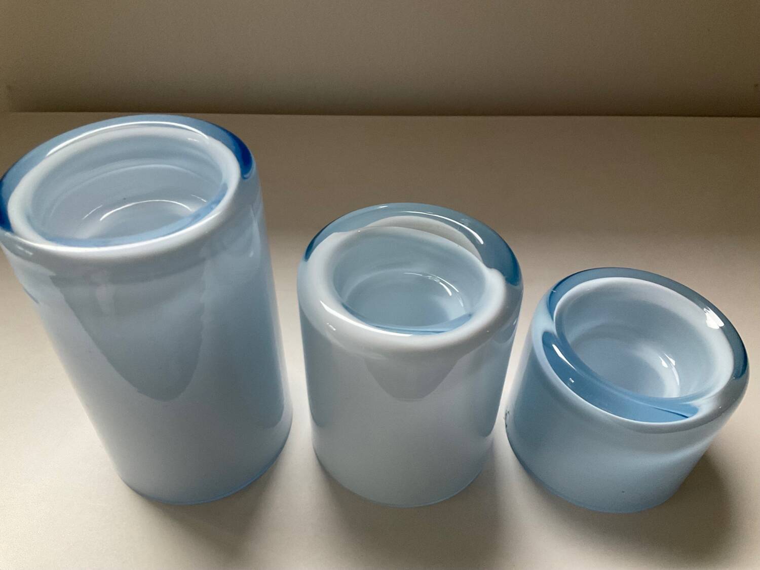 Trio of vintage candlesticks in double-layer glass paste