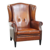 Sheepskin Wingback Chair with Warm Tones and Black Piping