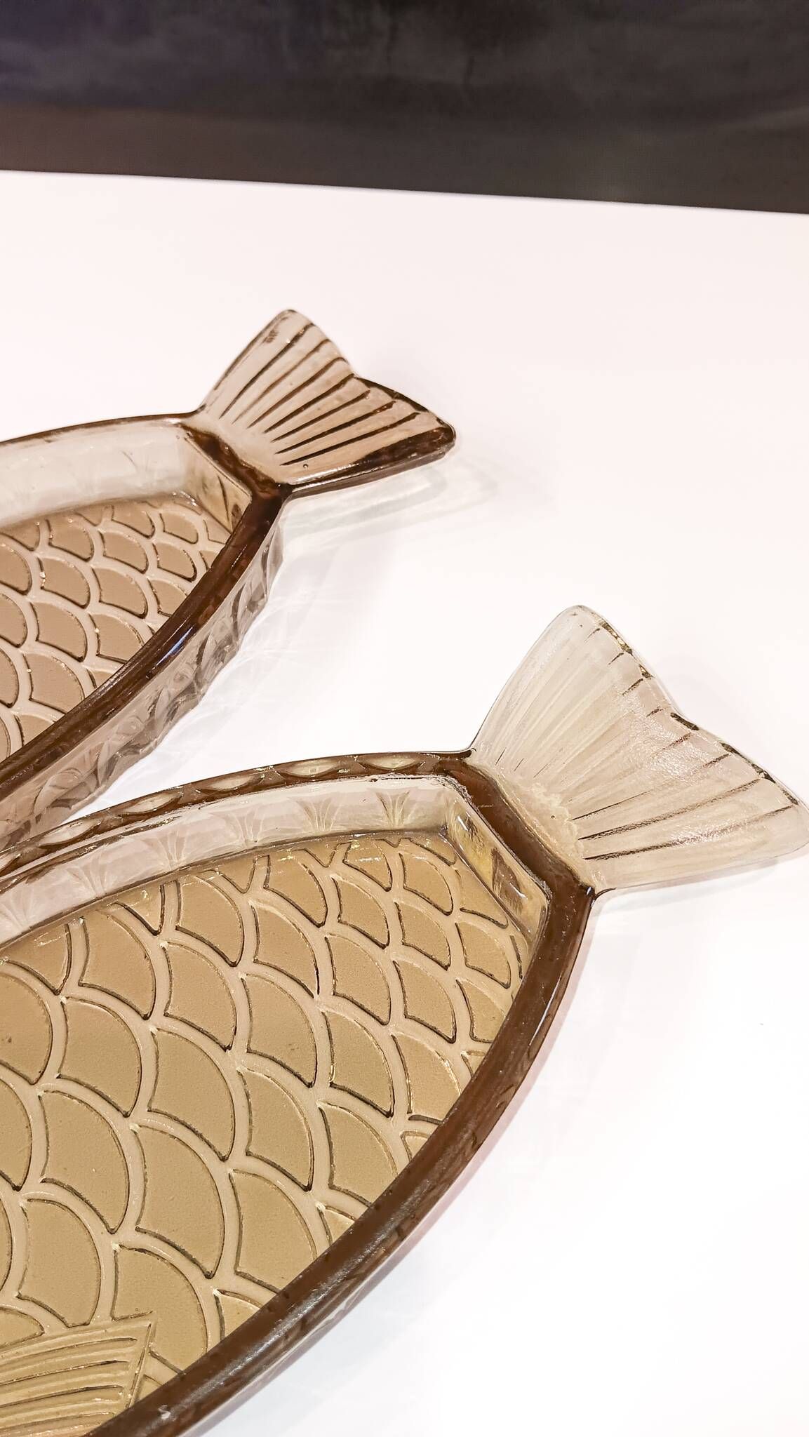 Set of 2 transparent smoked glass bowls in the shape of a fish.