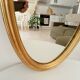 Miroir vintage ovale en bois doré années 60 77*41 cm