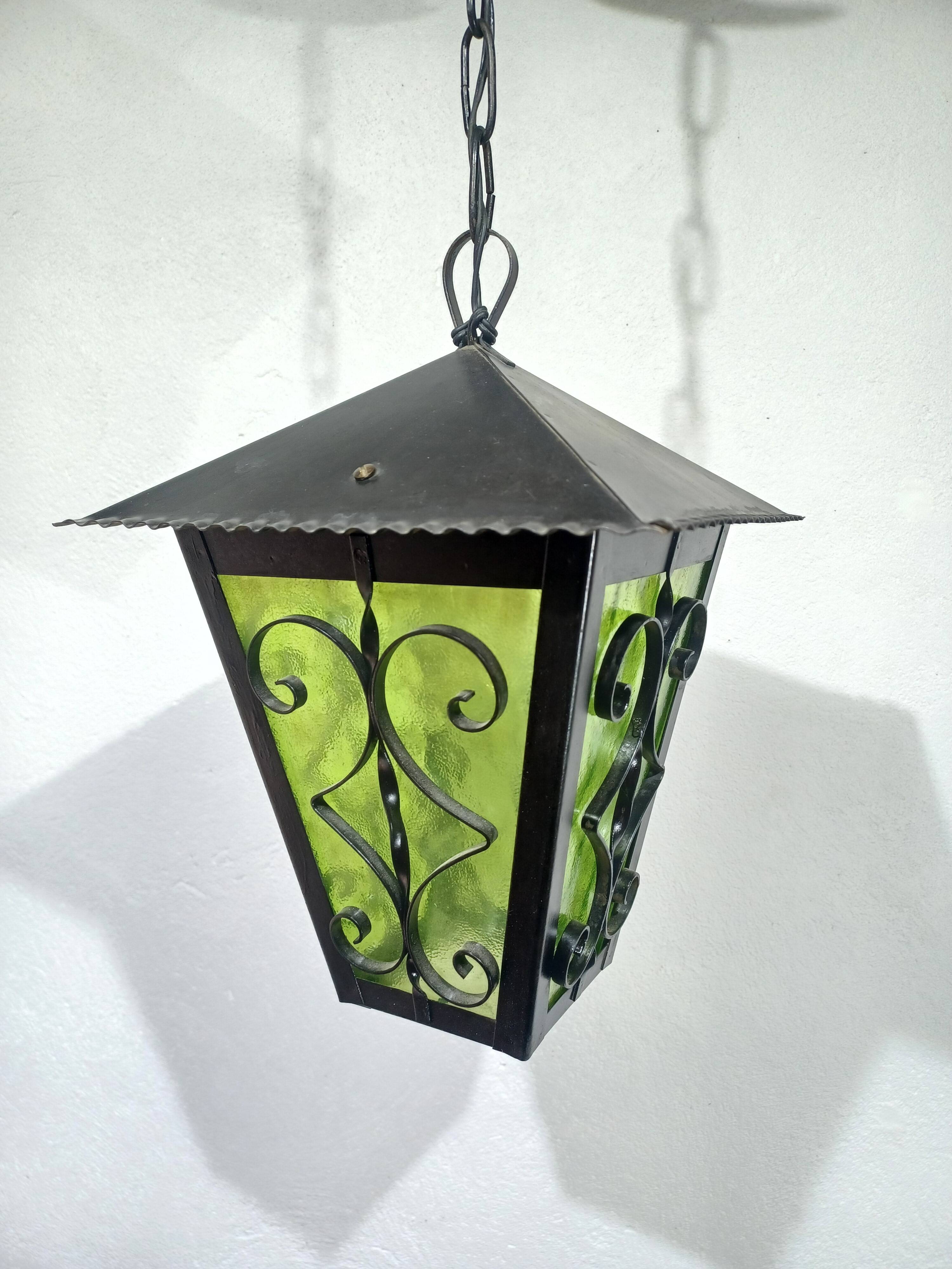 Wrought iron and green glass lantern