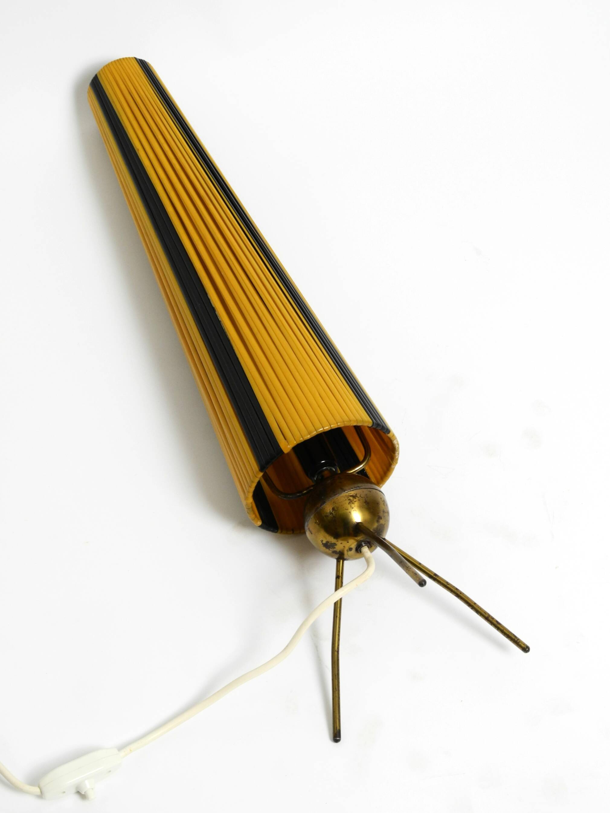 Mid Century tripod brass table lamp with a wrapped nylon strip lampshade