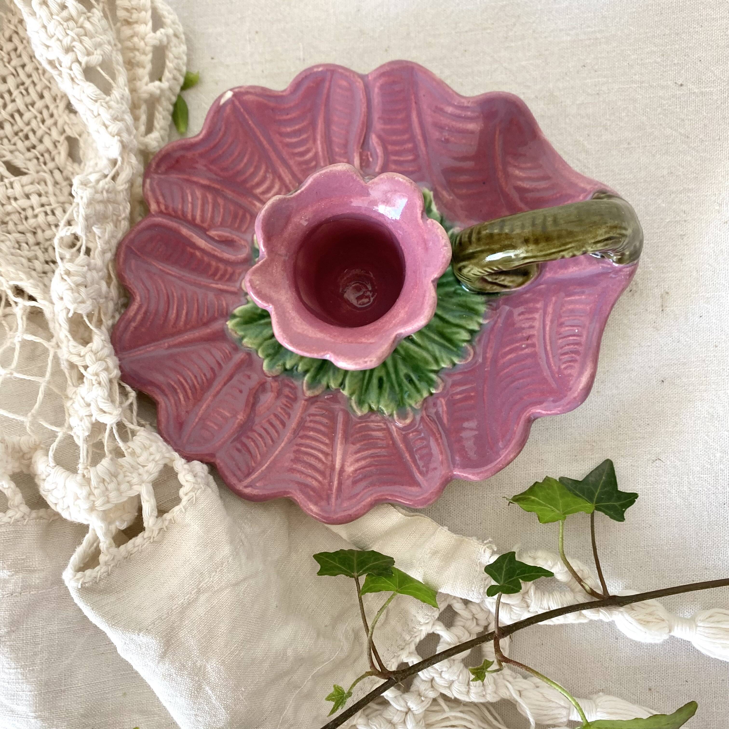 Antique slip candlestick depicting a flower