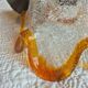 Vintage suspension with textured glass and amber-edged wood.