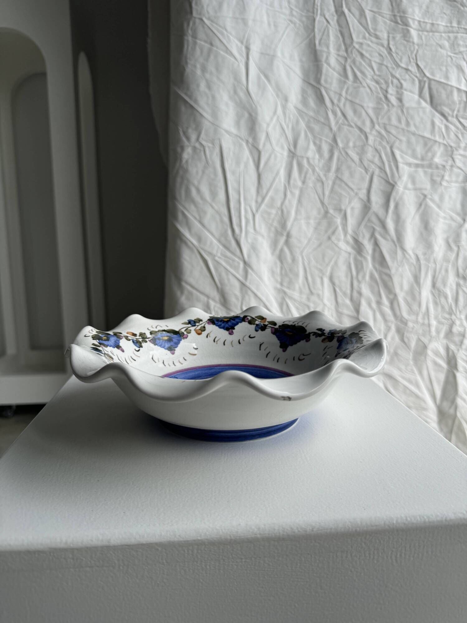 Small hand-painted earthenware salad bowl with garland of blue flowers, mark below