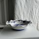 Small hand-painted earthenware salad bowl with garland of blue flowers, mark below
