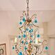 Italian chandelier with blue beads and gilded wood.