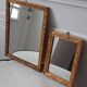 Paire de miroirs anciens en bois et en plâtre doré