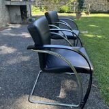 2 black cantilever armchairs