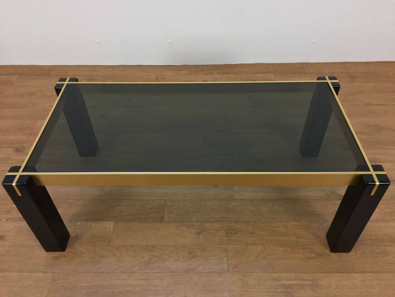 Italian coffee table from the 70s, smoked glass, black and gold lacquered wood.