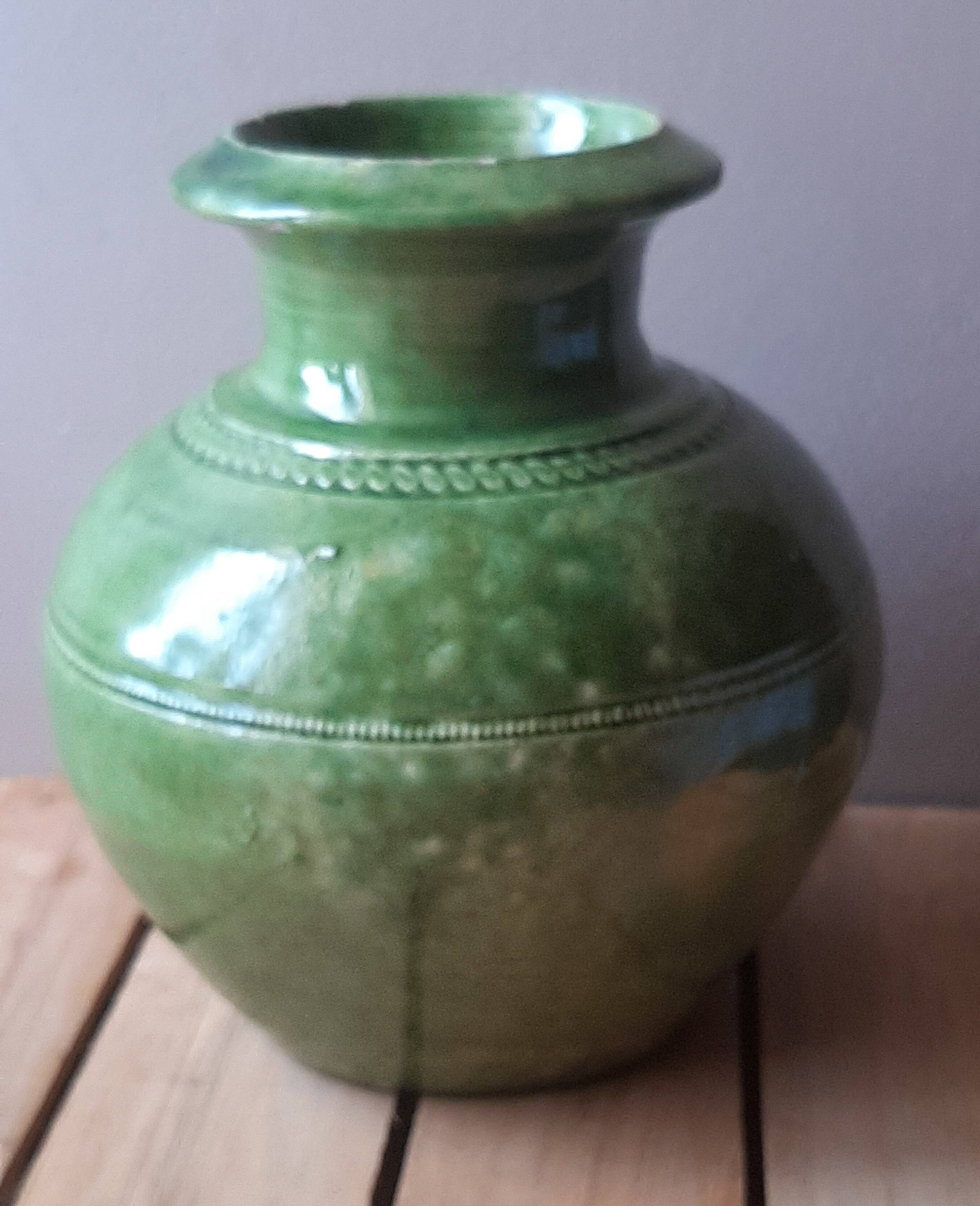 Ancient vase in glazed terracotta with green glaze.