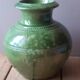 Ancient vase in glazed terracotta with green glaze.