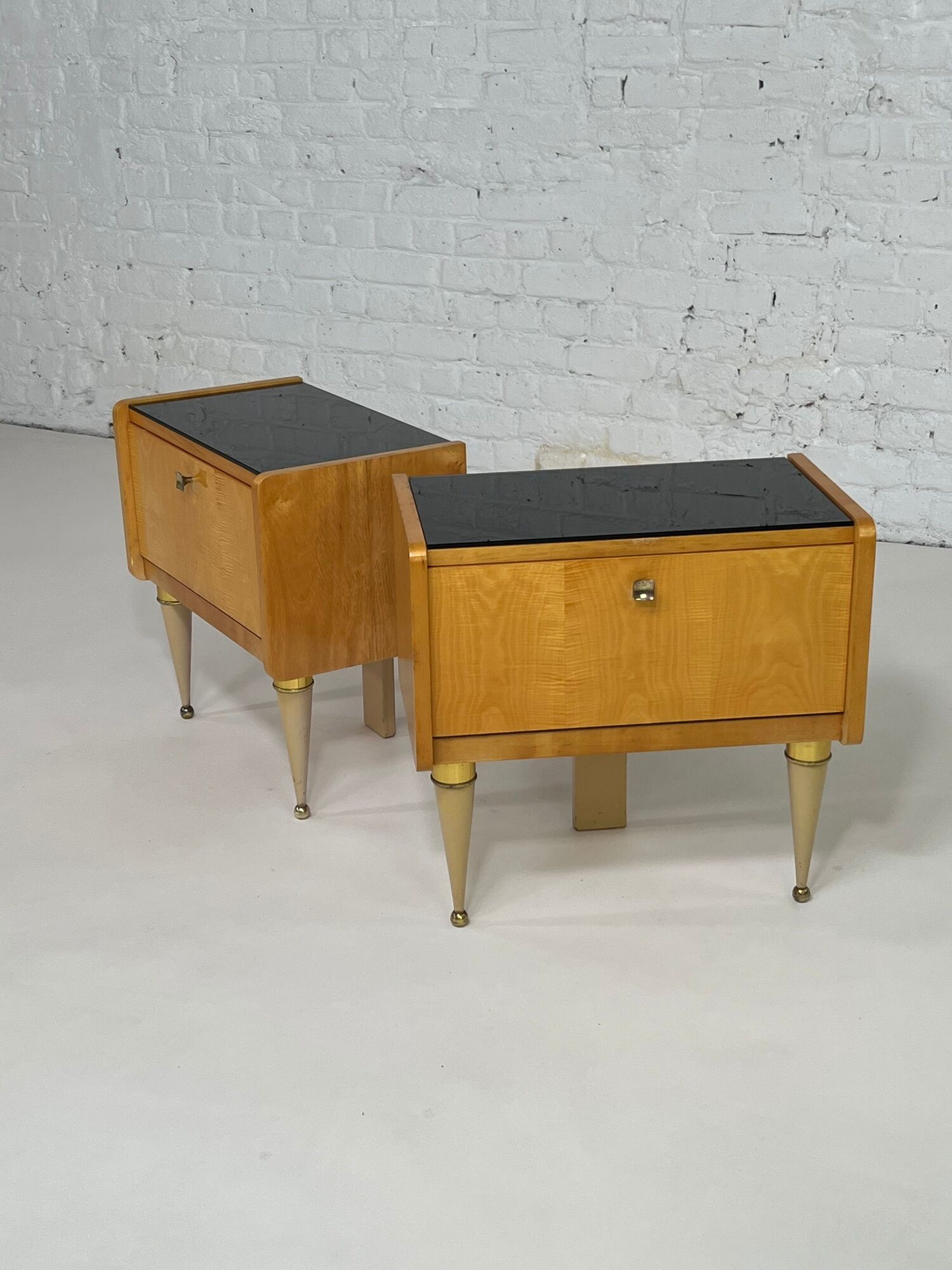 Pair of bedside tables in wood, brass and black glass top