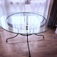 Round dining table in glass and wrought iron.