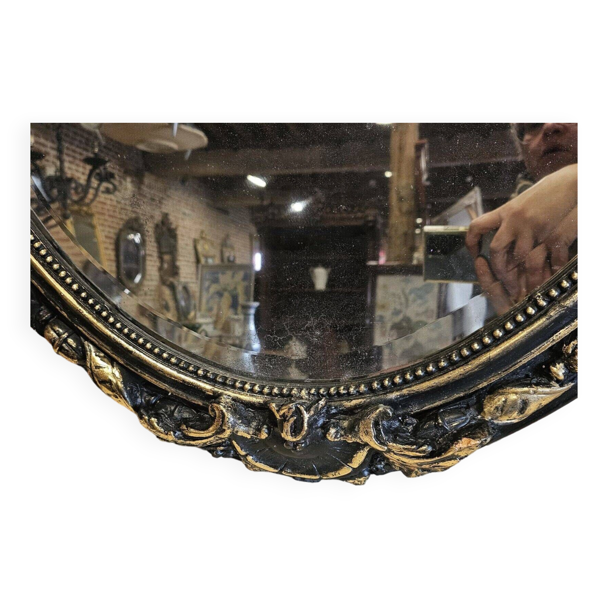 Old black and gold patinated oval mirror louis xv style