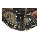Ancien miroir ovale patiné noir et doré style louis xv