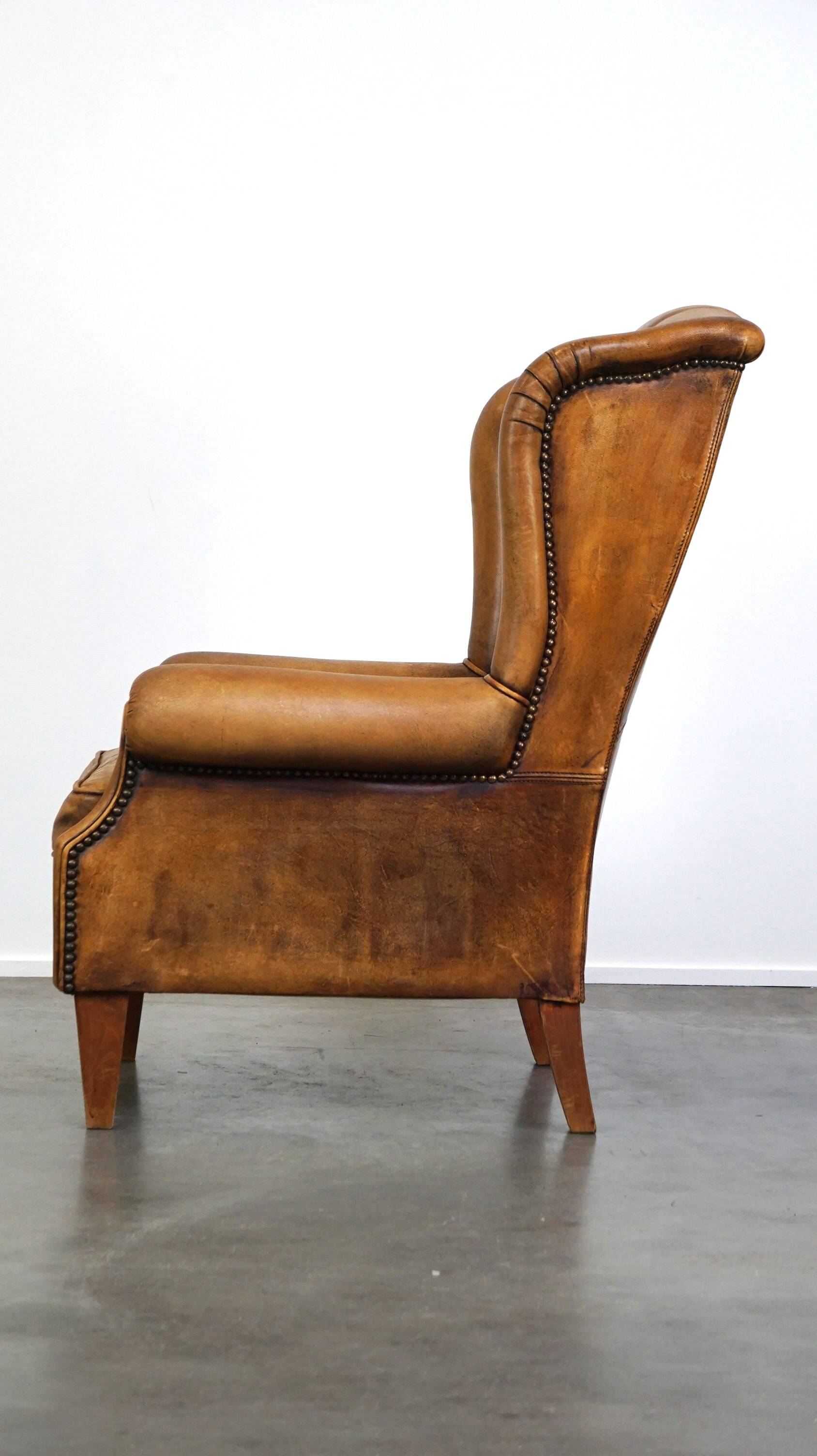 Sheepskin wingback chair with a unique design and a beautiful patina