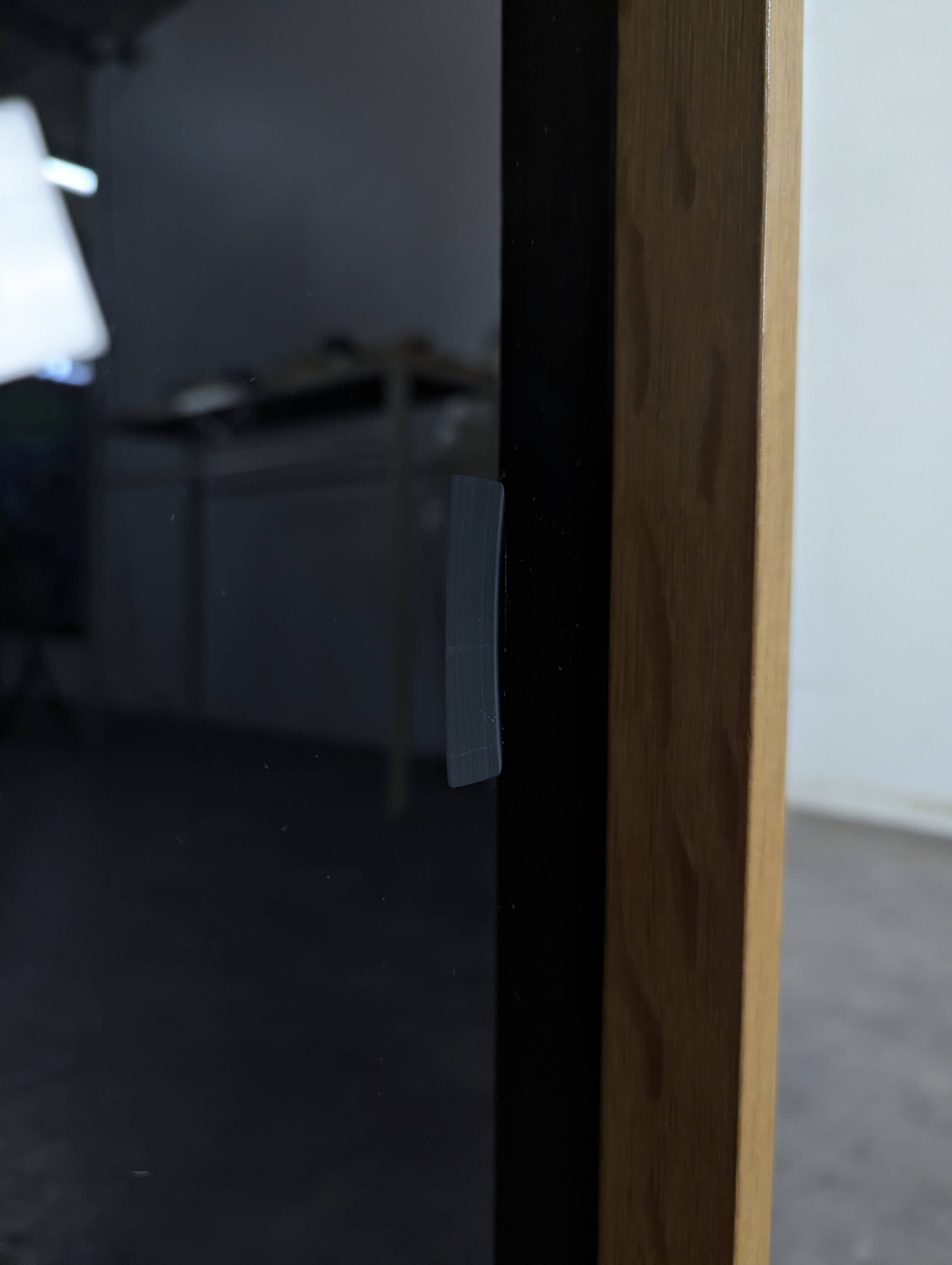 Pair of modernist sideboards with black glass doors in oak veneer.