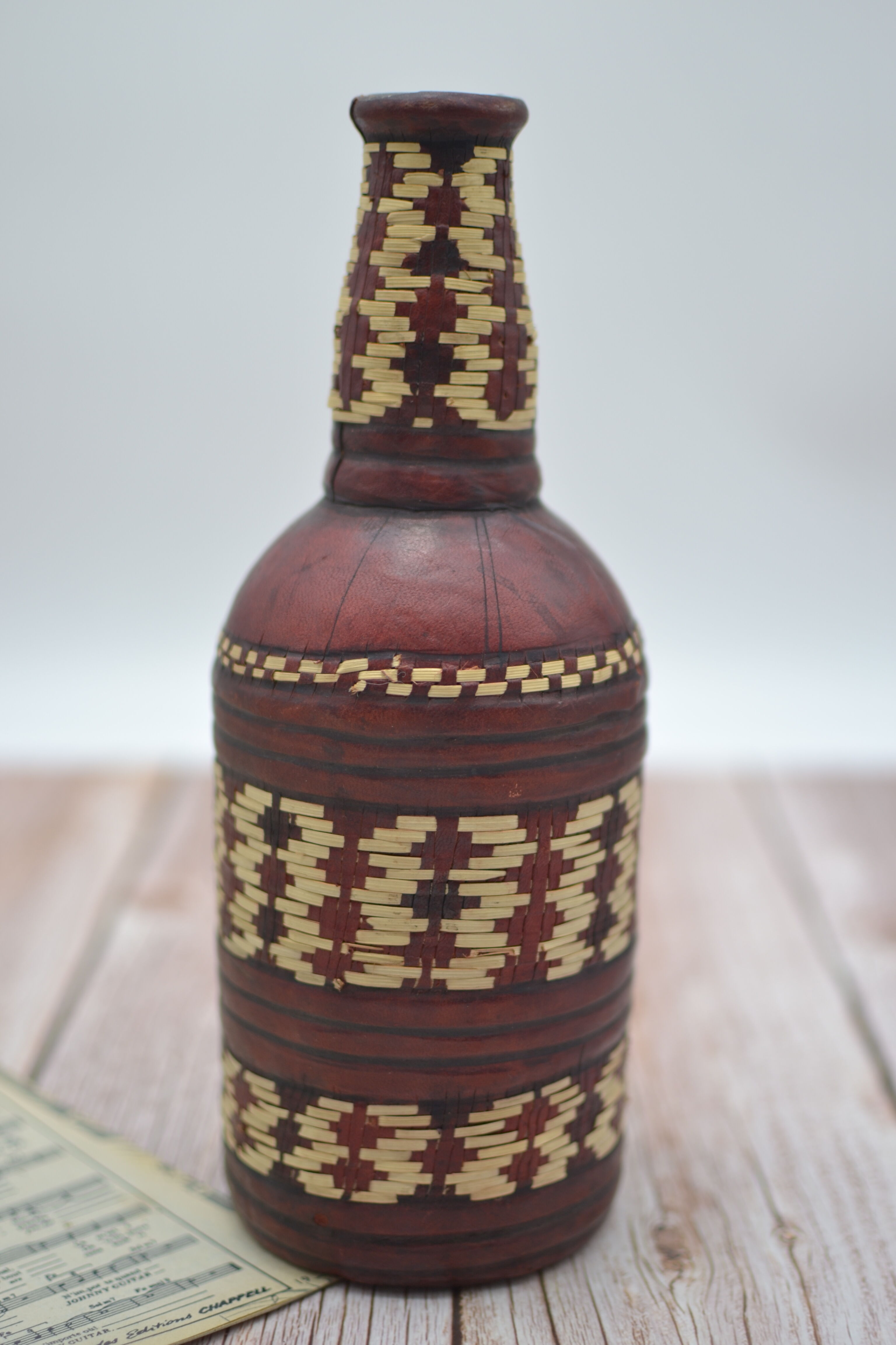 Set of 2 decorative vintage bottles covered with leather & wicker