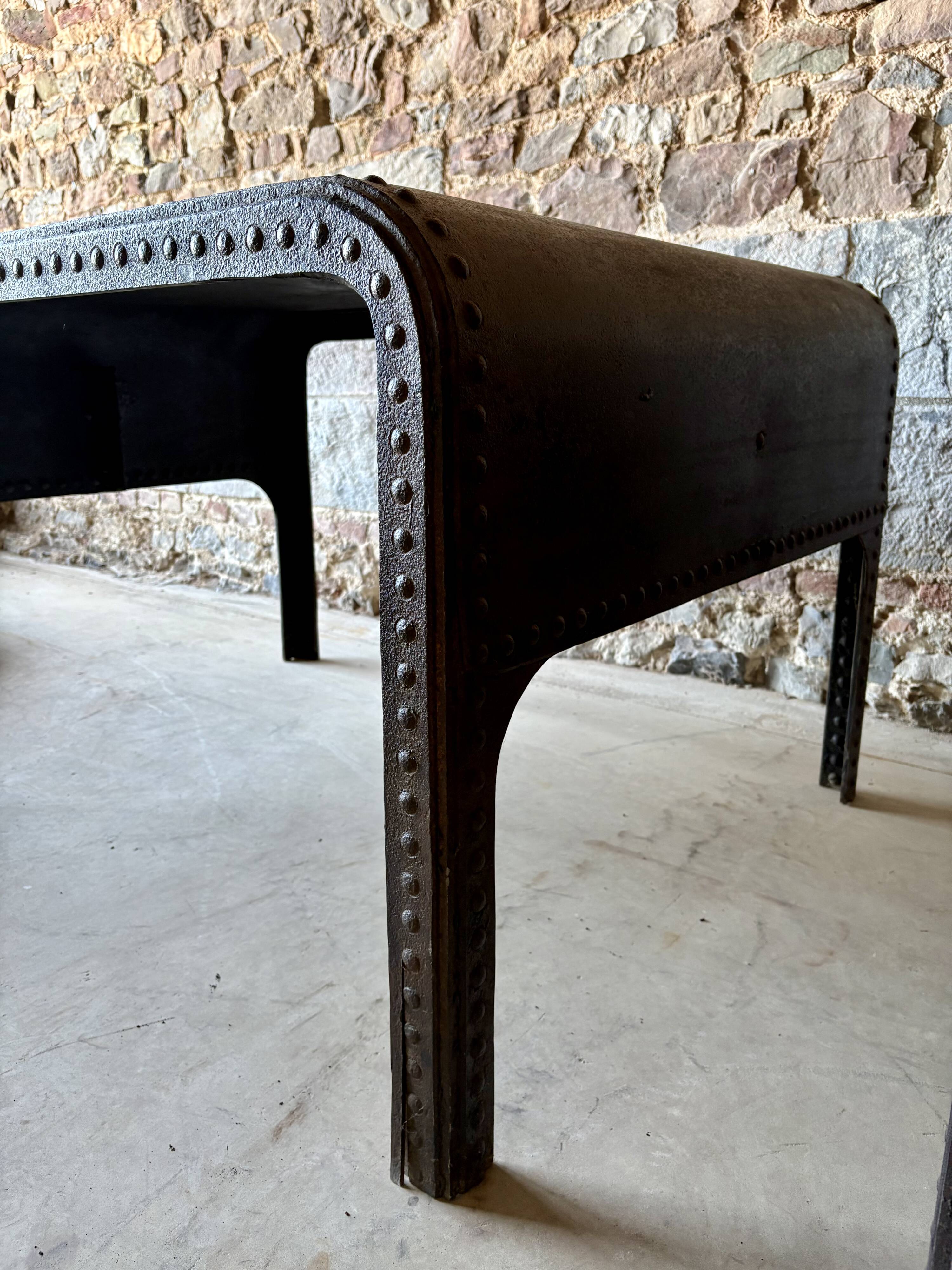 Pair of large riveted metal industrial tables