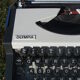 Revised typewriter and Olympia Traveller luxury with his satchel
