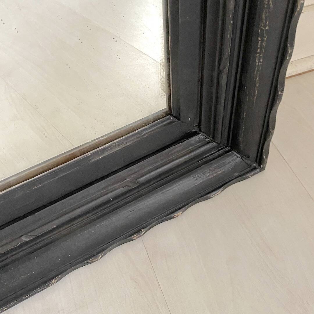 1950s mirror, matte black wood with a patina.
