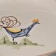 Plat à décor de coq , signé