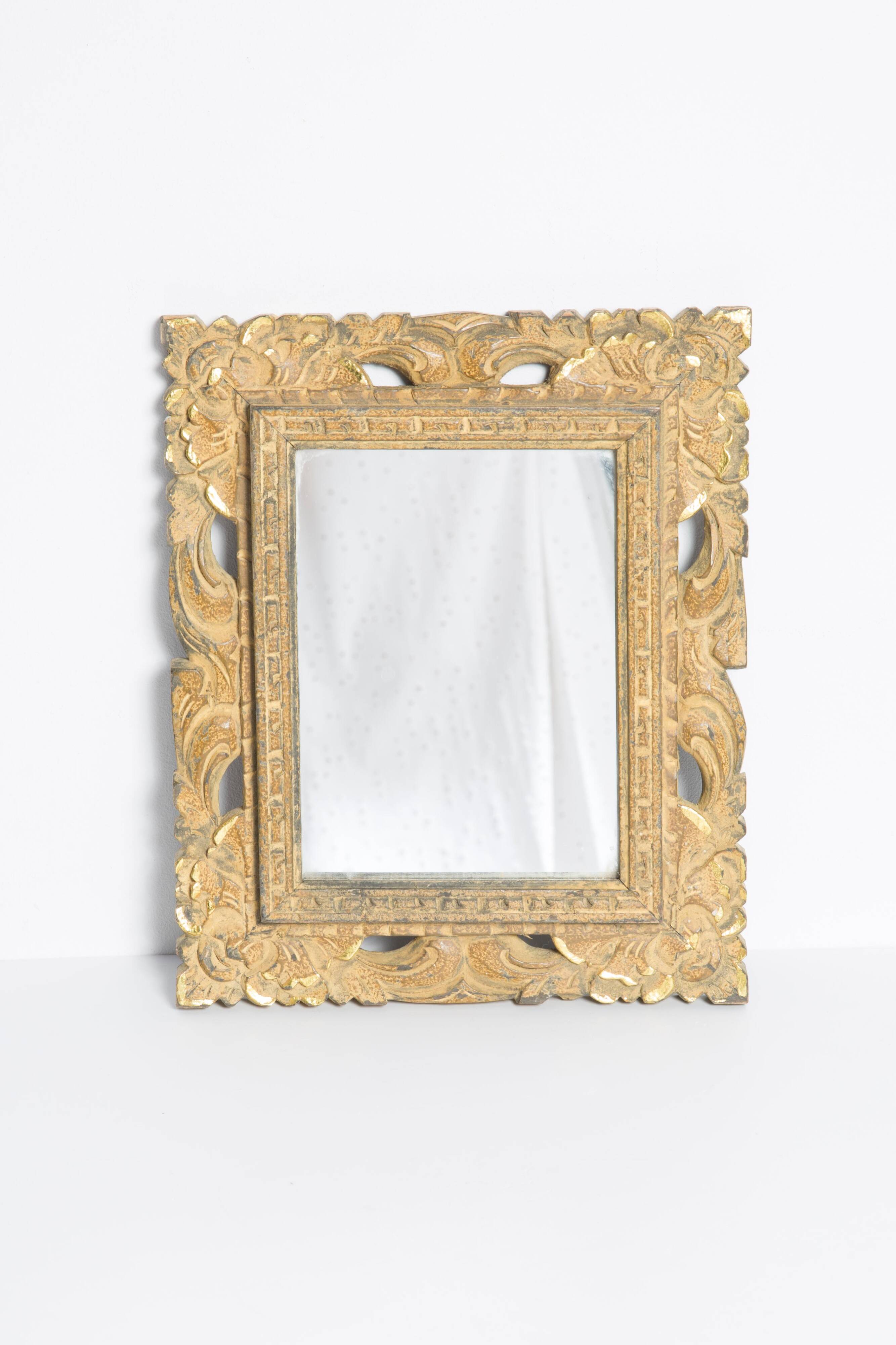 Decorative gold mirror mid-century in a wooden frame, Italy, 1960s.