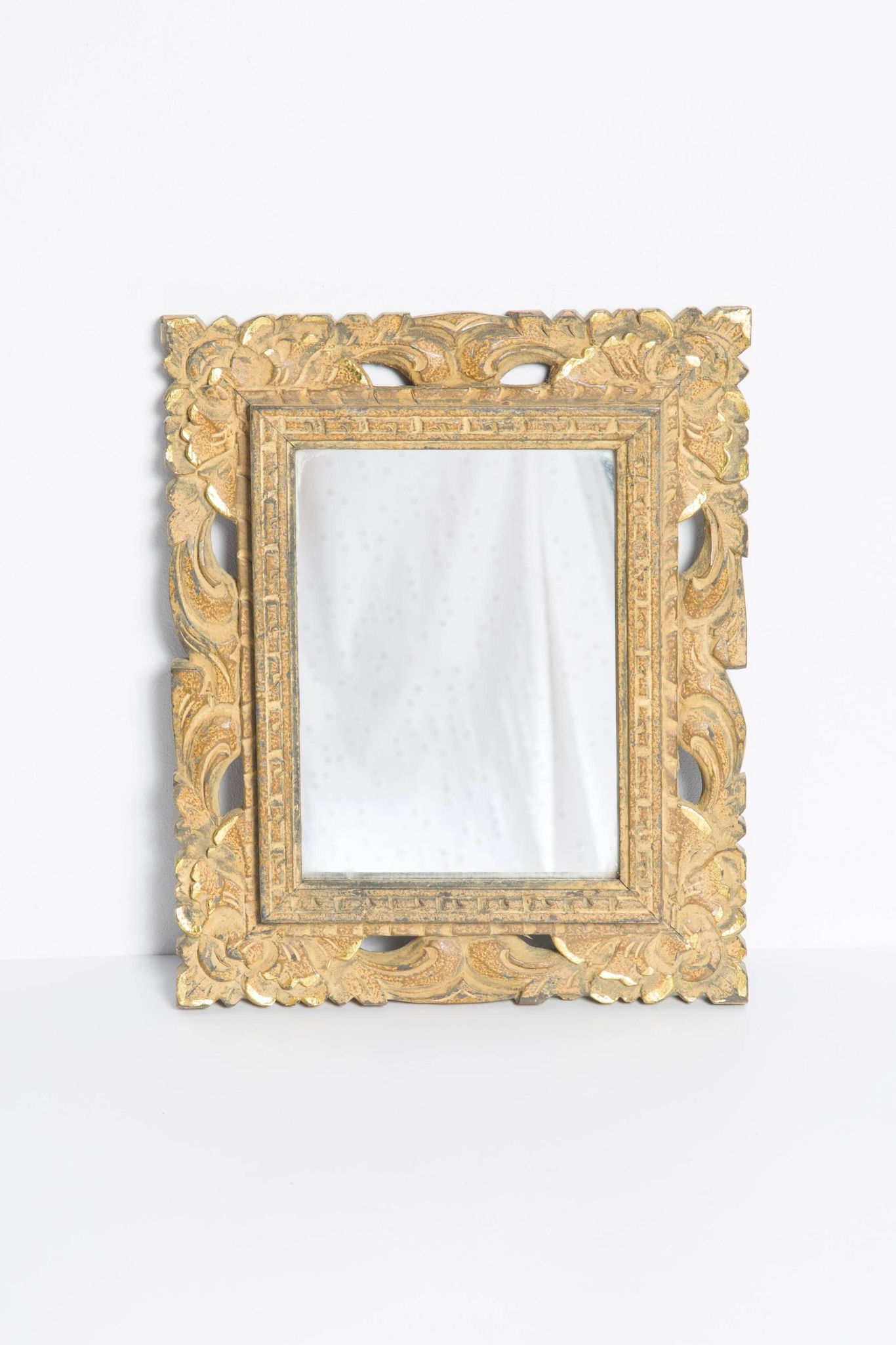 Decorative gold mirror mid-century in a wooden frame, Italy, 1960s.