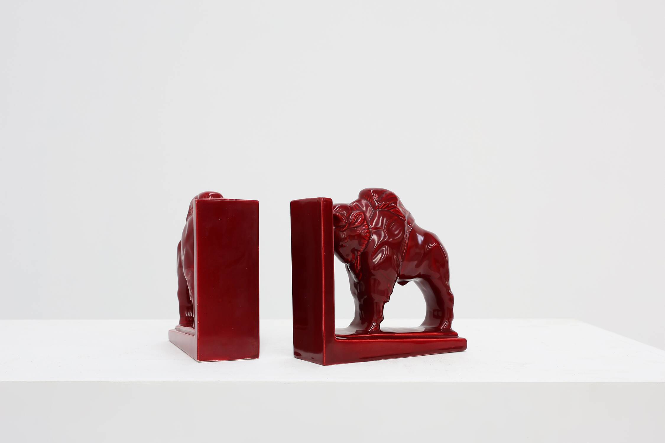 Pair of red glazed ceramic Bison ox bookends in Art Deco style, Belgium